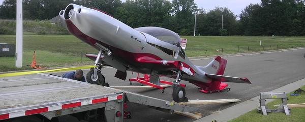Small airplane transported on a trailer